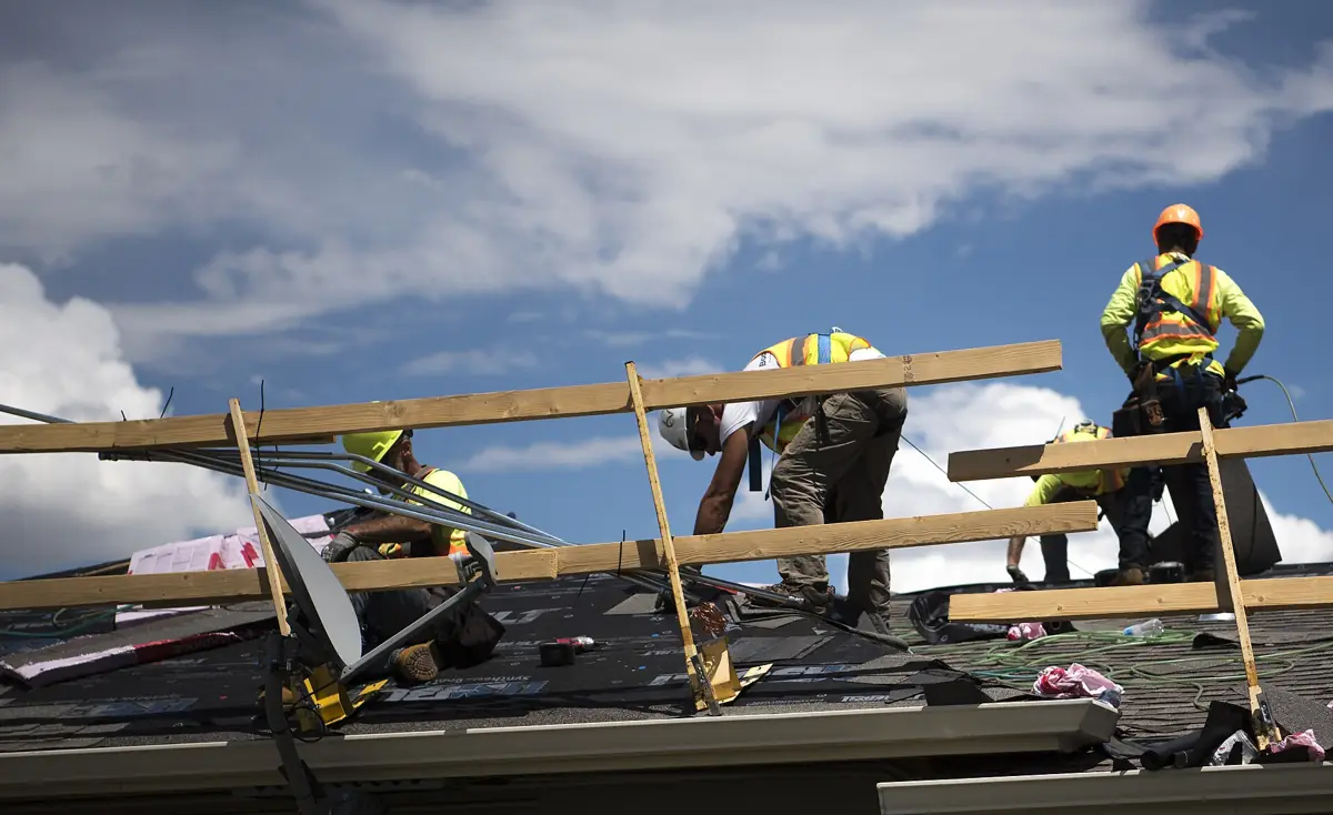 Roofing crew installing new shingles
